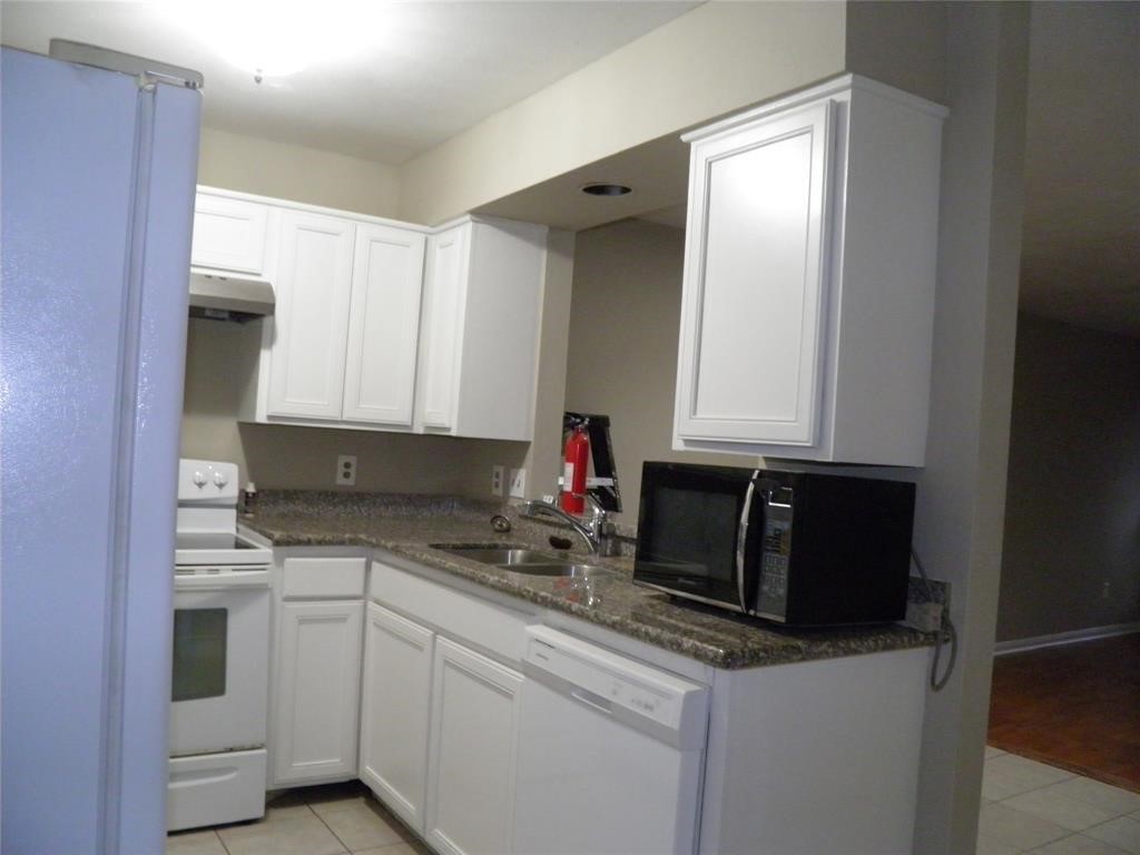 9901 Sharpcrest Street, Unit D1 Houston, TX 77036 - Photo 4 of 8 a kitchen with stainless steel appliances granite countertop a sink stove and cabinets