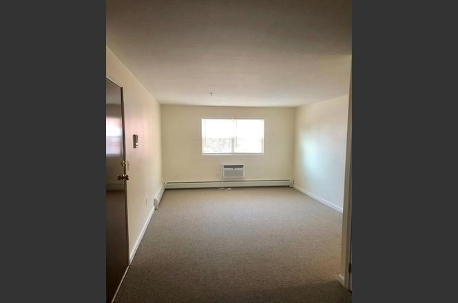 361 Hildreth Street, Unit 24 Lowell, MA 01850 - Photo 1 of 9 an empty room with a window
