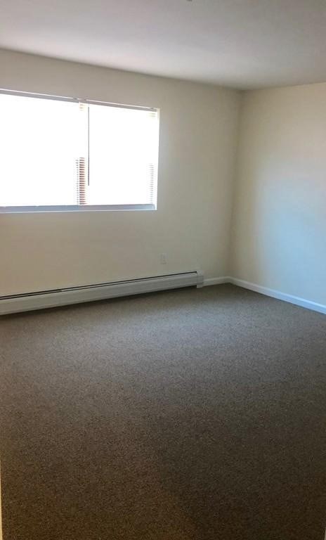 361 Hildreth Street, Unit 24 Lowell, MA 01850 - Photo 4 of 9 a view of an empty room and window
