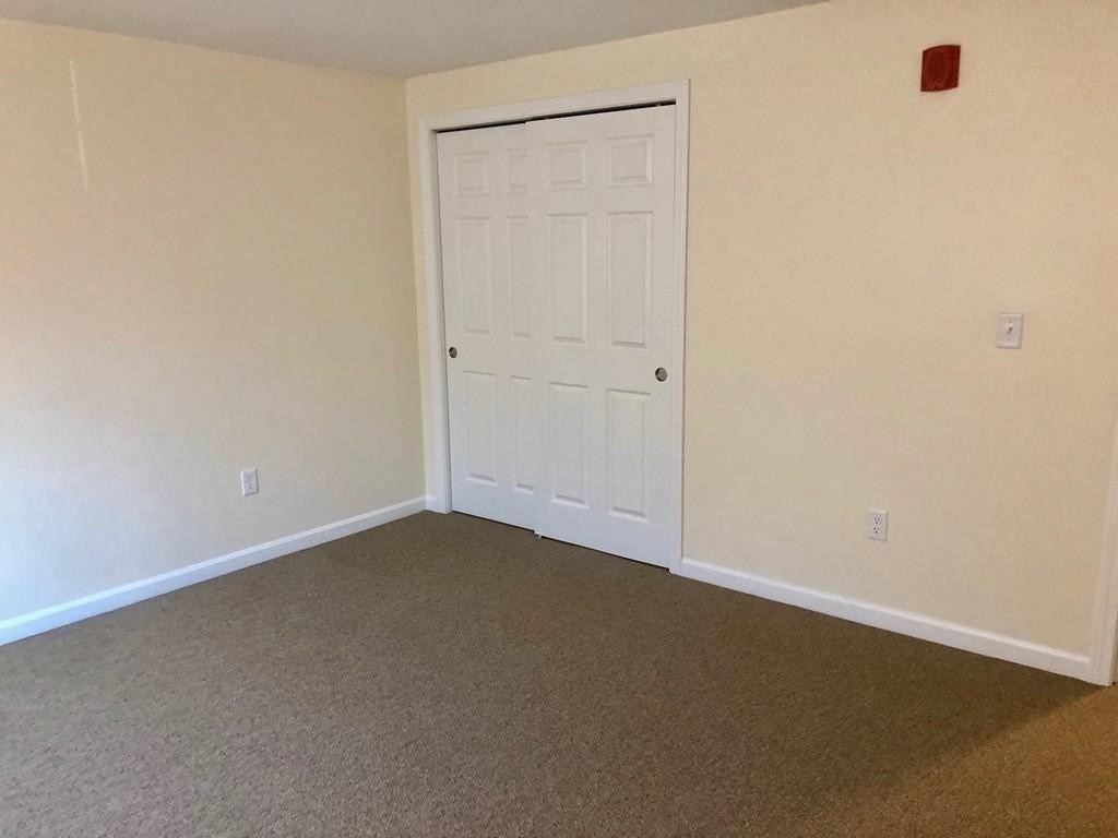 361 Hildreth Street, Unit 24 Lowell, MA 01850 - Photo 5 of 9 an empty room with closet area