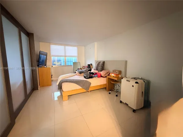 a bed room with a bed and a large window