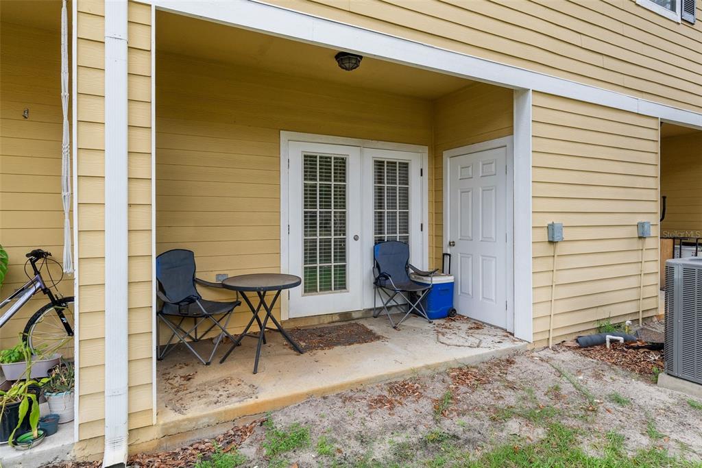 2927 Southwest 35th Place, Unit 113 Gainesville, FL 32608 - Photo 23 of 27 a view of a lounge chairs in the backyard