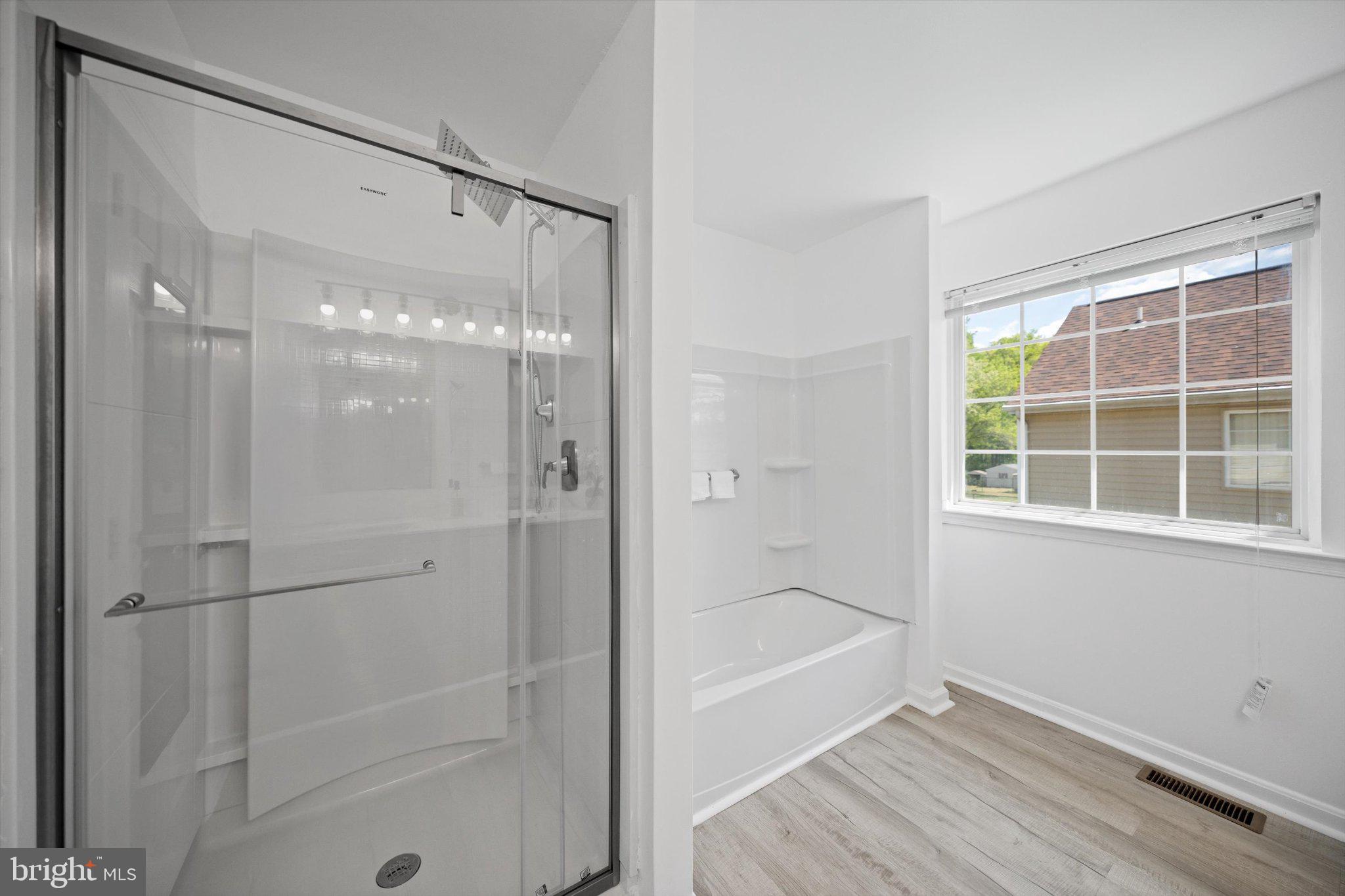 12908 Windbrook Drive Clinton, MD 20735 - Photo 17 of 67 a bathroom with a bathtub and a shower