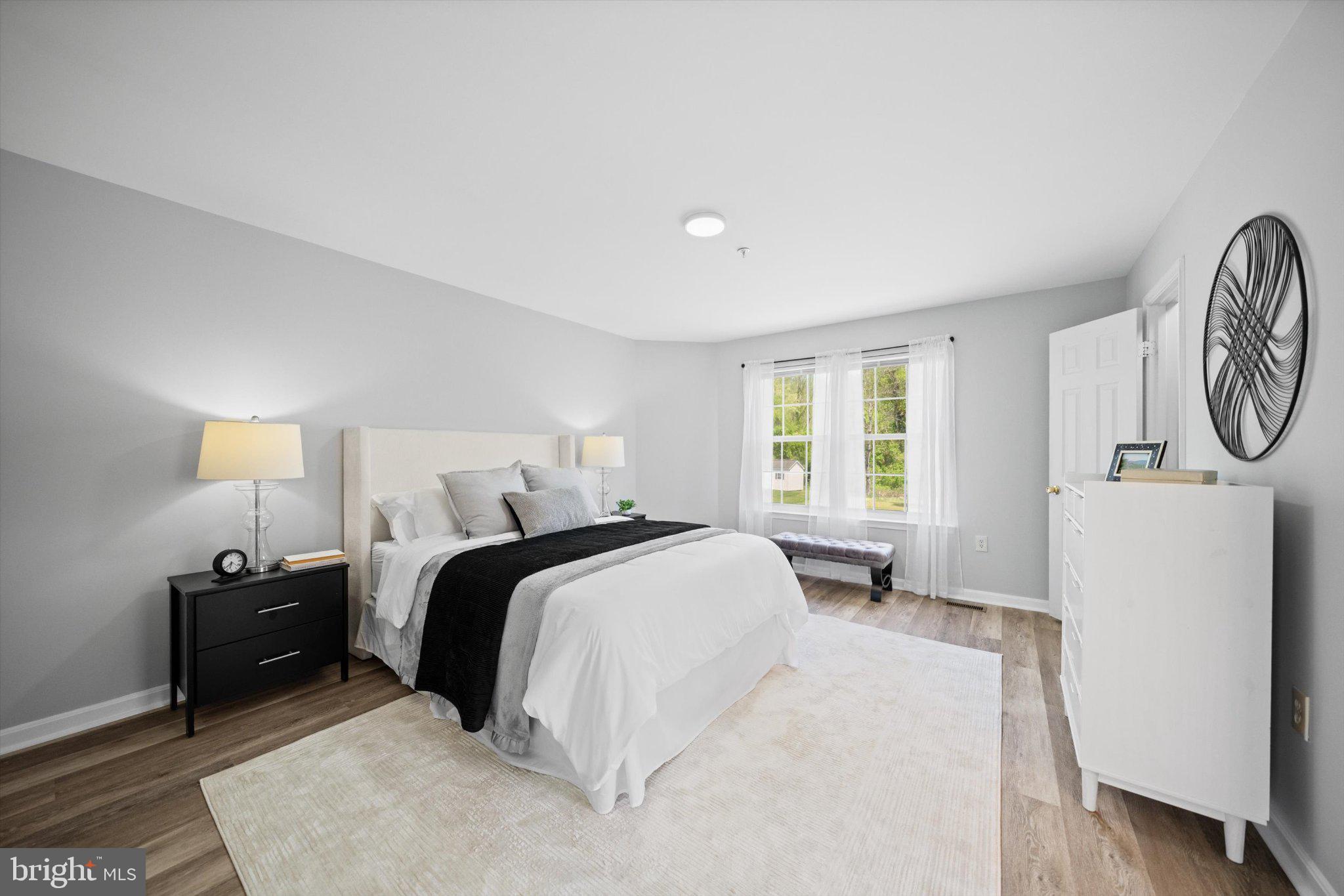 12908 Windbrook Drive Clinton, MD 20735 - Photo 20 of 67 a bed room with a bed a mirror and a window