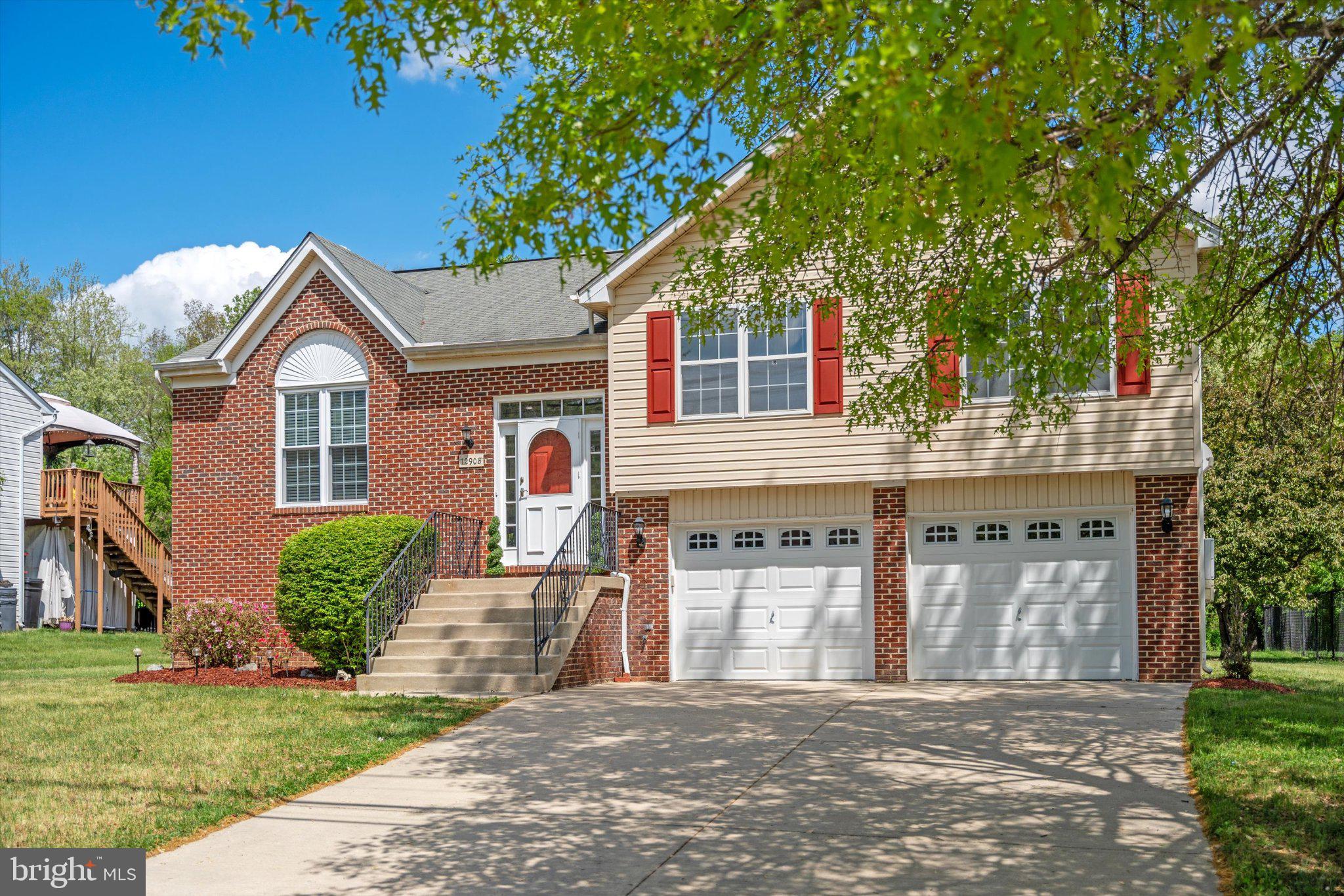 12908 Windbrook Drive Clinton, MD 20735 - Photo 2 of 67 a front view of a house with garden