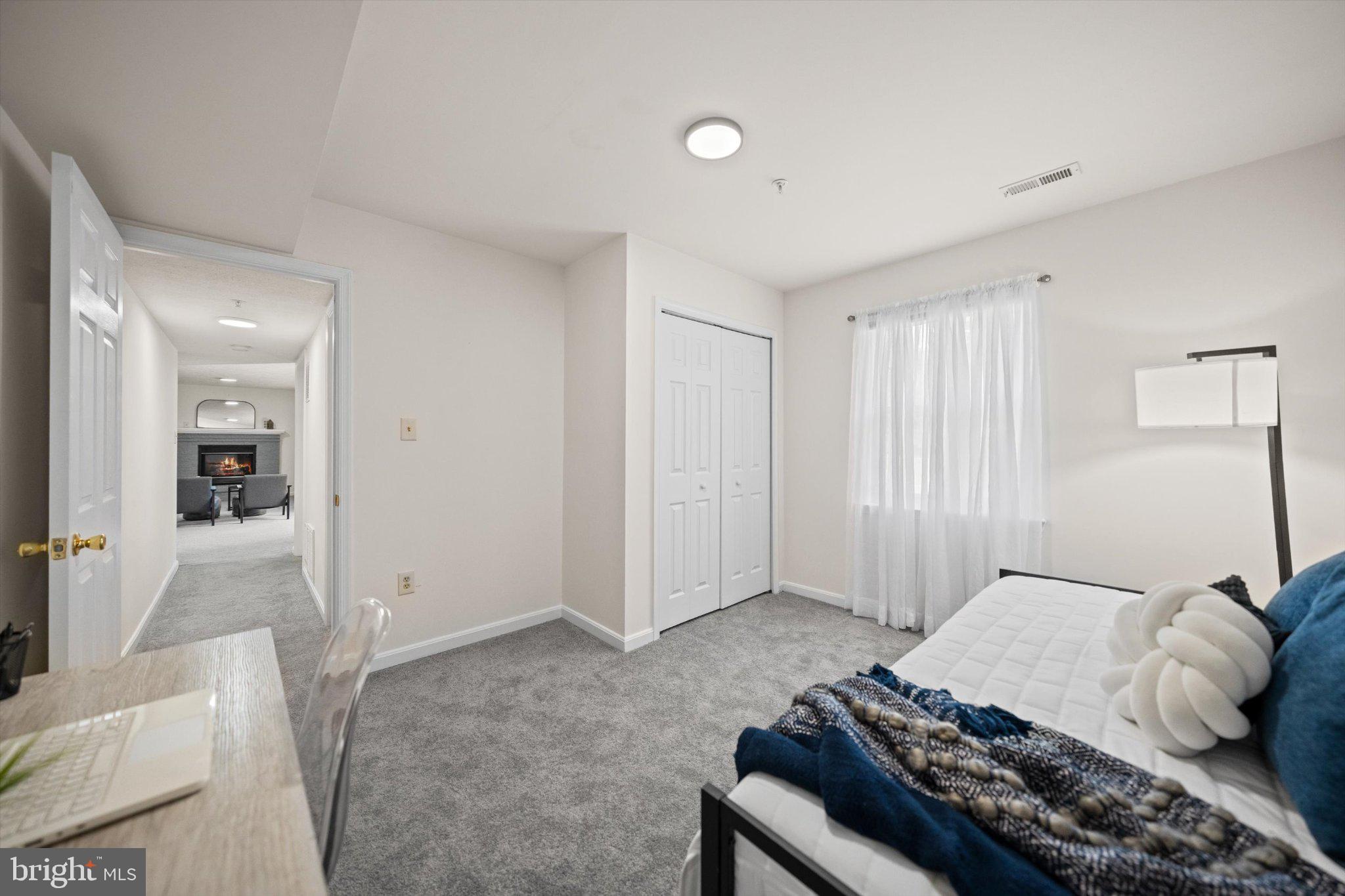 12908 Windbrook Drive Clinton, MD 20735 - Photo 22 of 67 a bedroom with a bed and a couch