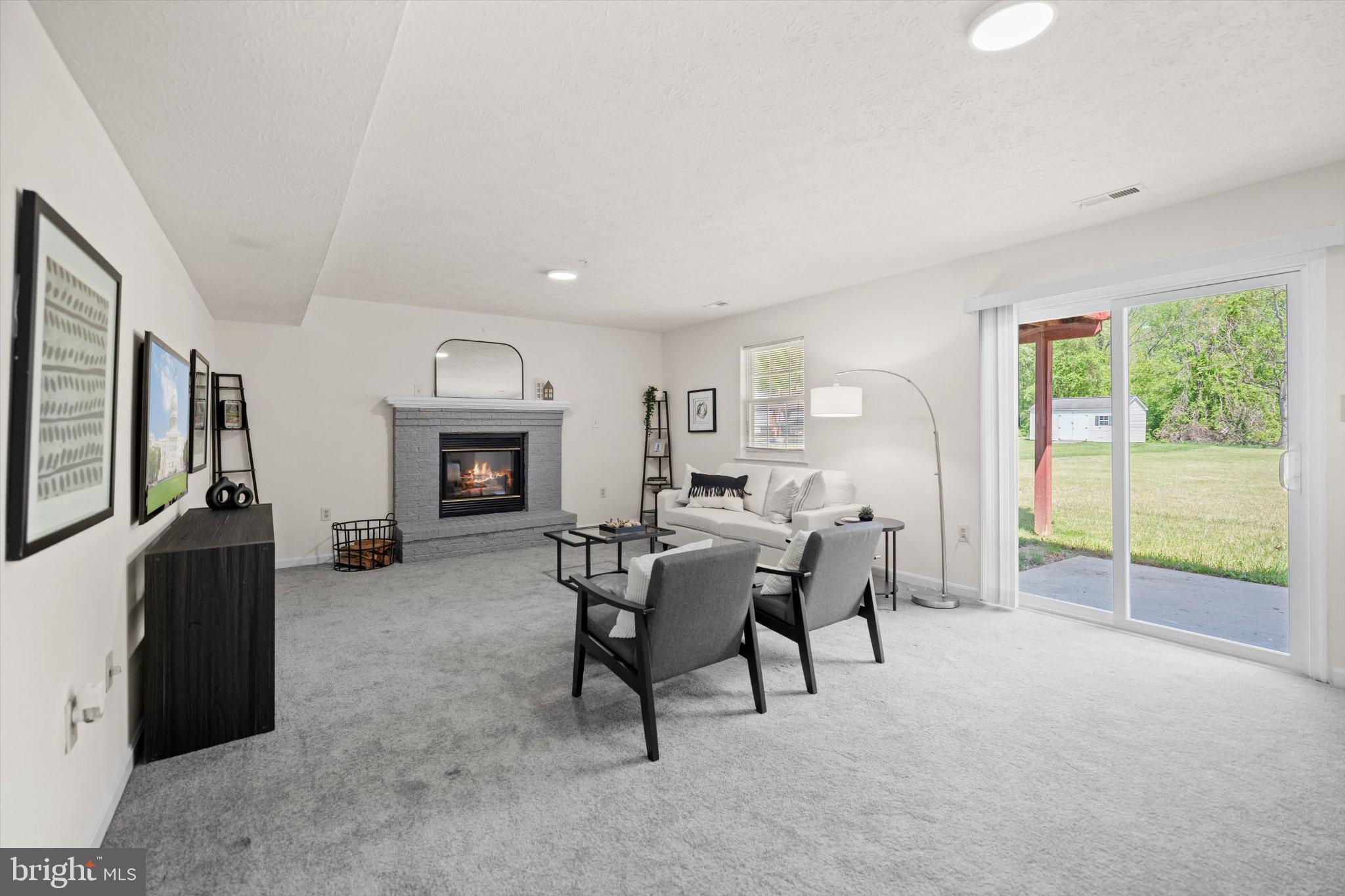 12908 Windbrook Drive Clinton, MD 20735 - Photo 26 of 67 a living room with furniture and a fireplace