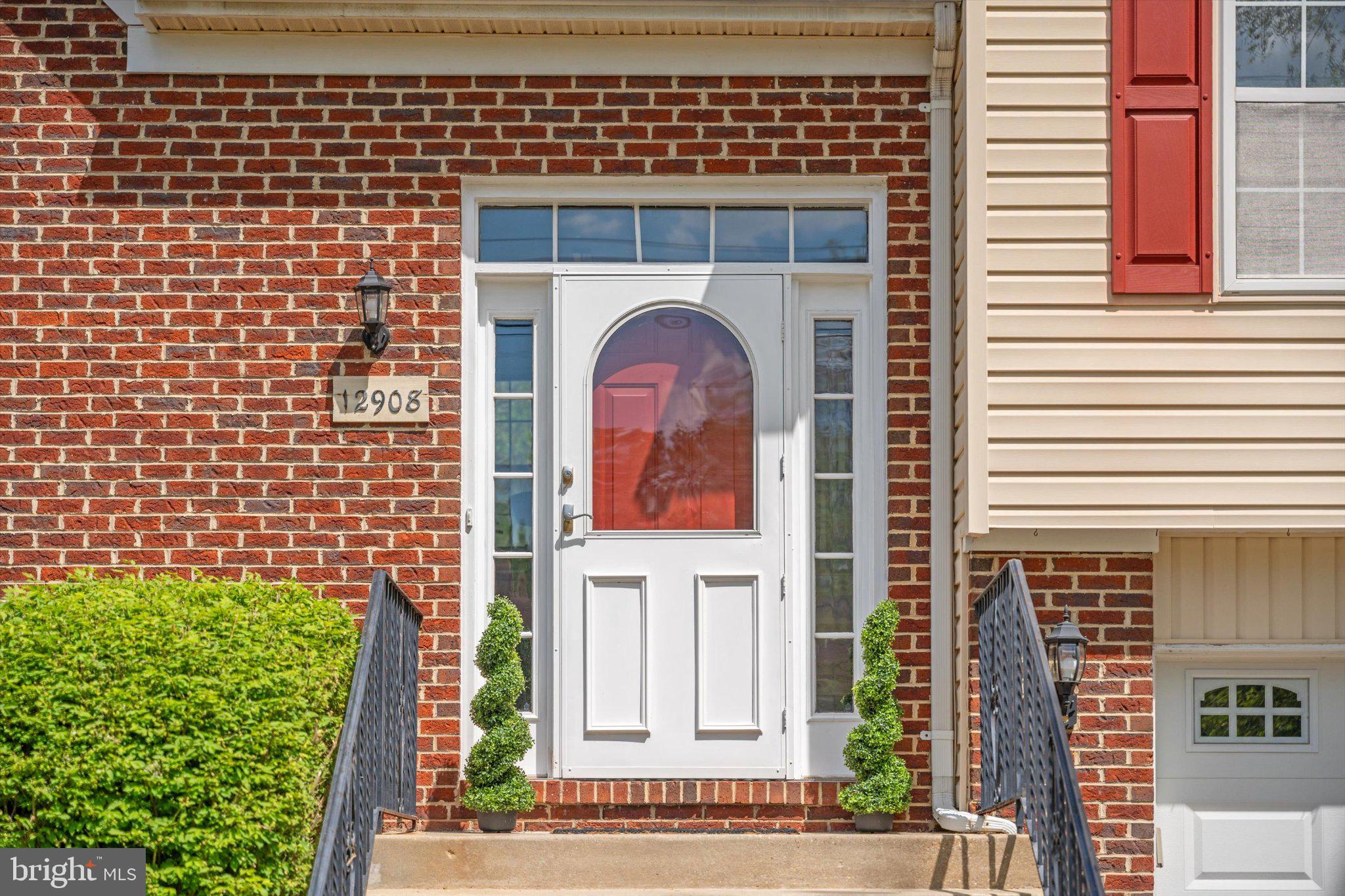 12908 Windbrook Drive Clinton, MD 20735 - Photo 3 of 67 a front view of a house with a garden