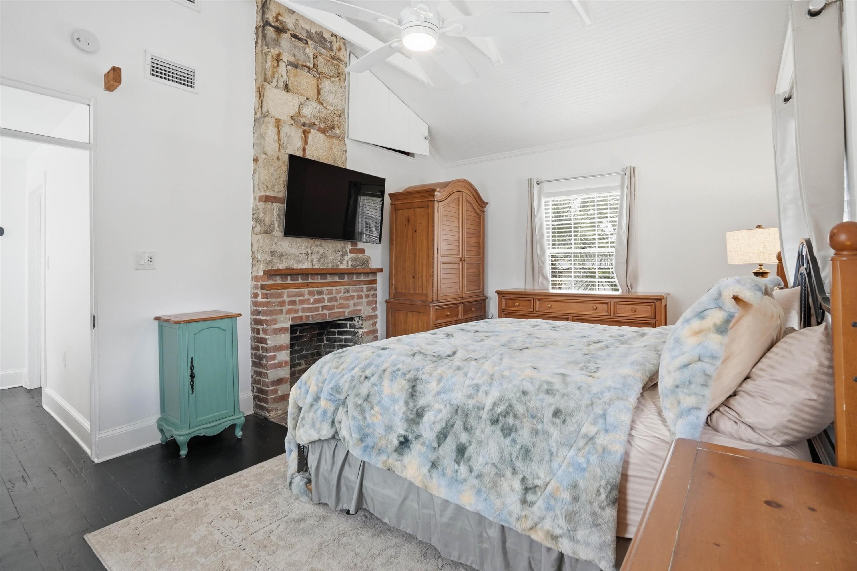 76 Oneida Street St. Augustine, FL 32084 - Photo 23 of 38 a bedroom with a bed and a television