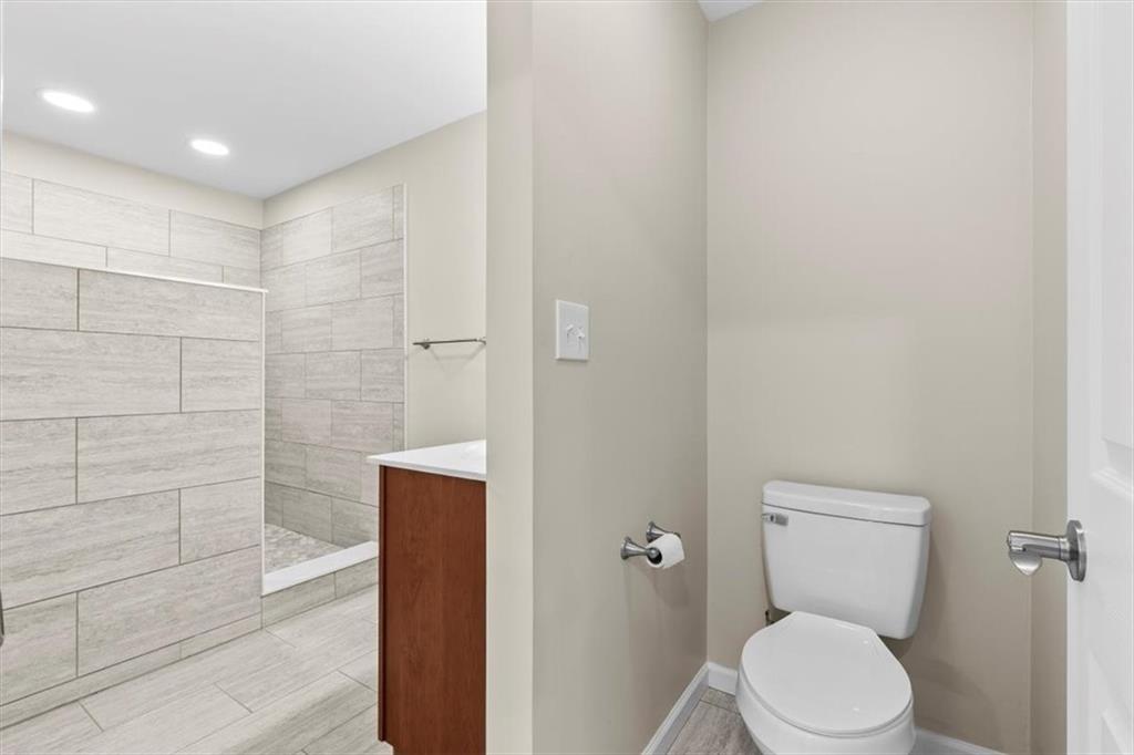 227 Rolling Wood Circle Northwest Rome, GA 30165 - Photo 14 of 31 a bathroom with a toilet and a shower