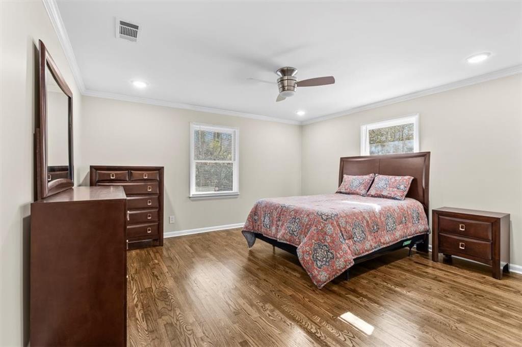 227 Rolling Wood Circle Northwest Rome, GA 30165 - Photo 19 of 31 a bedroom with a bed and wooden floor