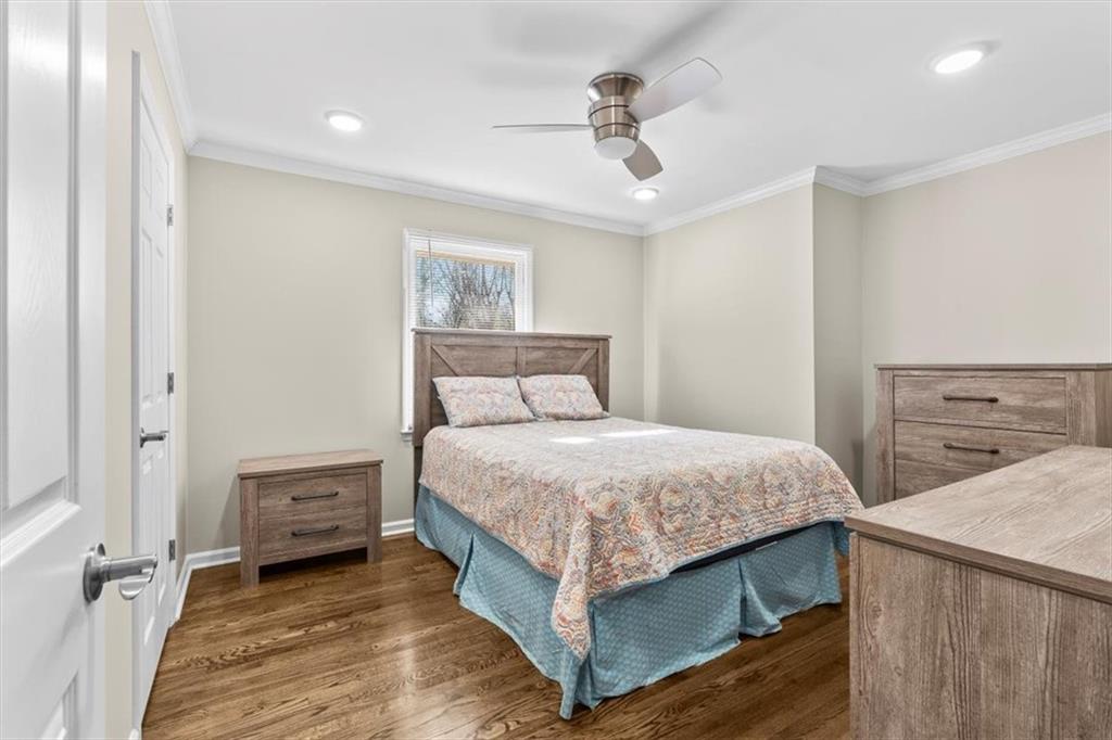 227 Rolling Wood Circle Northwest Rome, GA 30165 - Photo 21 of 31 a bedroom with a bed and a chandelier