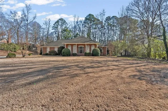 a backyard of a house with large trees