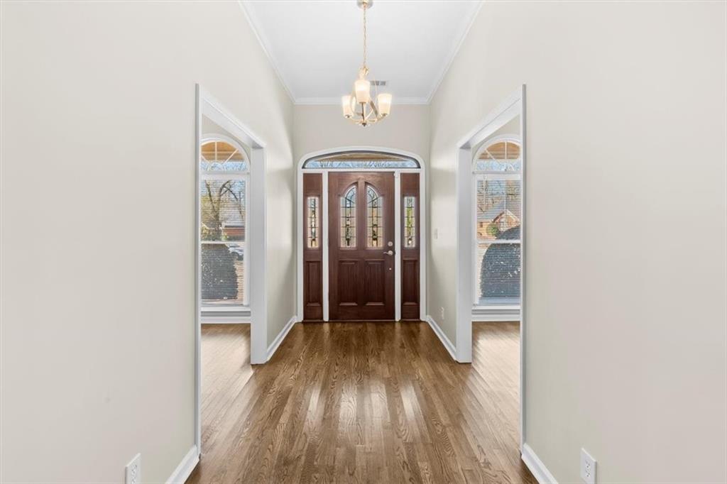 227 Rolling Wood Circle Northwest Rome, GA 30165 - Photo 3 of 31 a view of a hallway with wooden floor and a chandelier