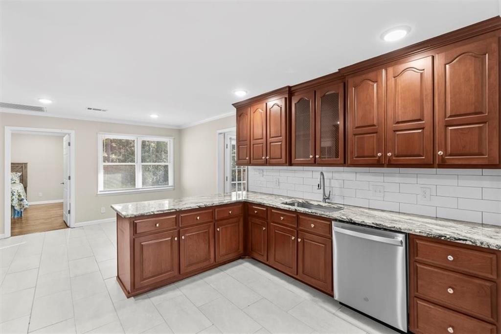 227 Rolling Wood Circle Northwest Rome, GA 30165 - Photo 5 of 31 a kitchen with stainless steel appliances granite countertop wooden cabinets a sink and dishwasher with wooden floor