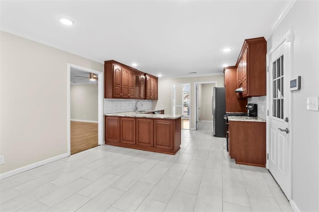 227 Rolling Wood Circle Northwest Rome, GA 30165 - Photo 9 of 31 a large kitchen with a refrigerator and a stove