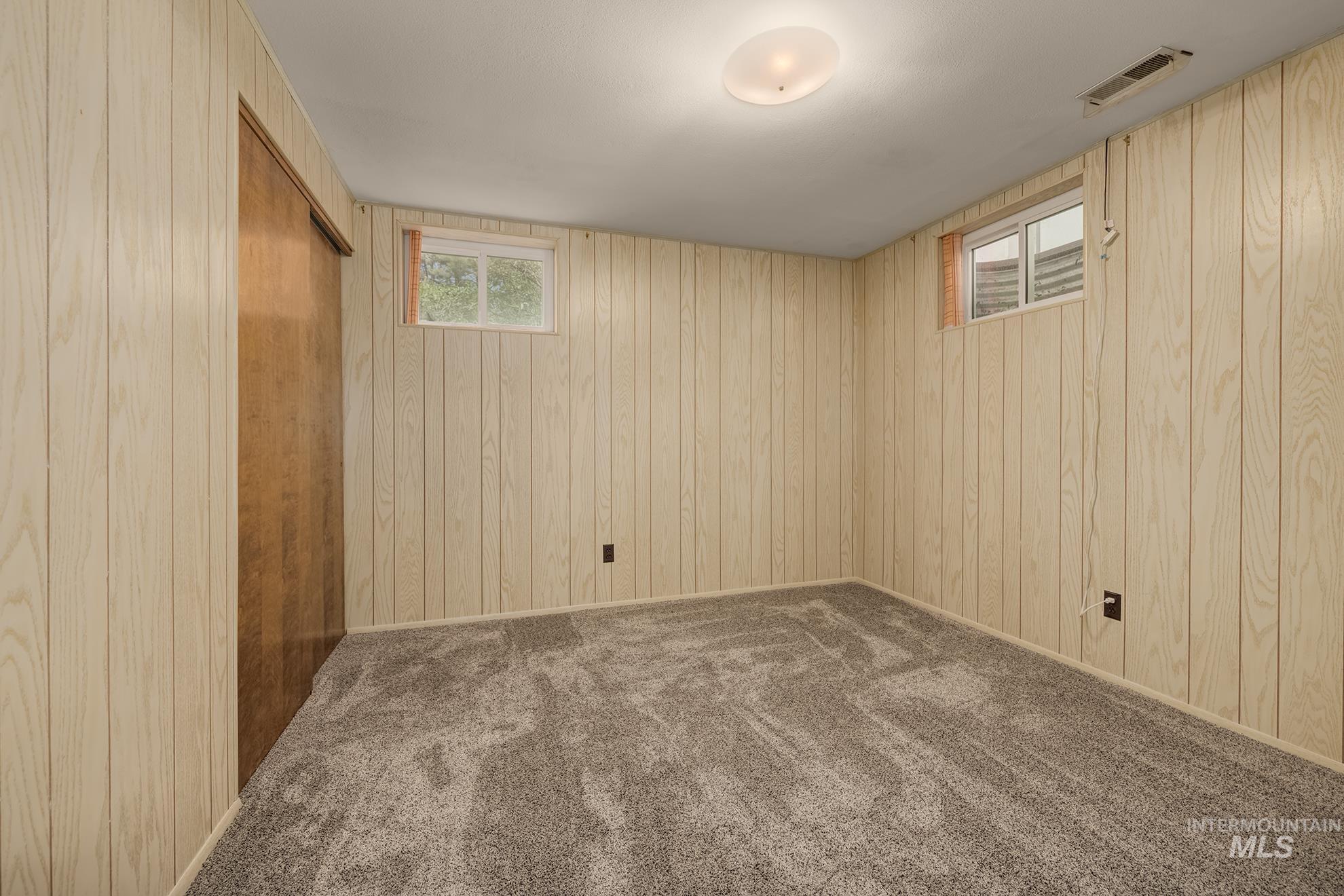 748 Pringle Road Weiser, ID 83672 - Photo 28 of 47 Room featuring light wood-finish paneled walls and grey carpet