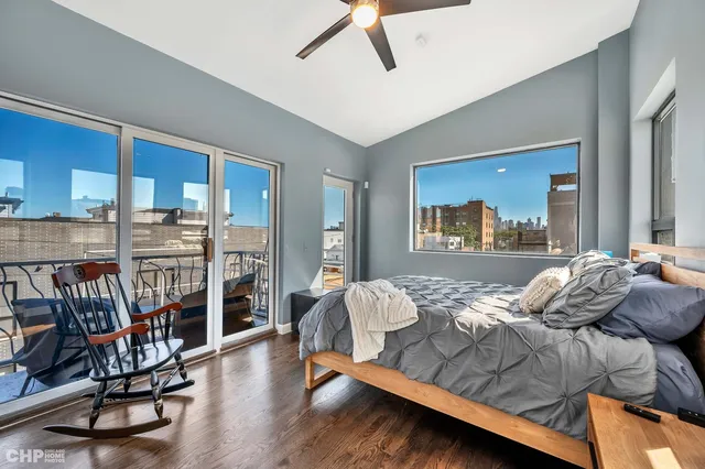 a bedroom with furniture and a wooden floor