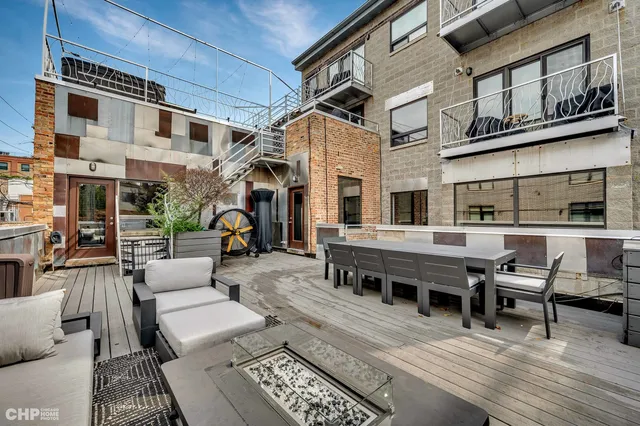 a view of a patio with couches and a dining table and chairs with wooden floor
