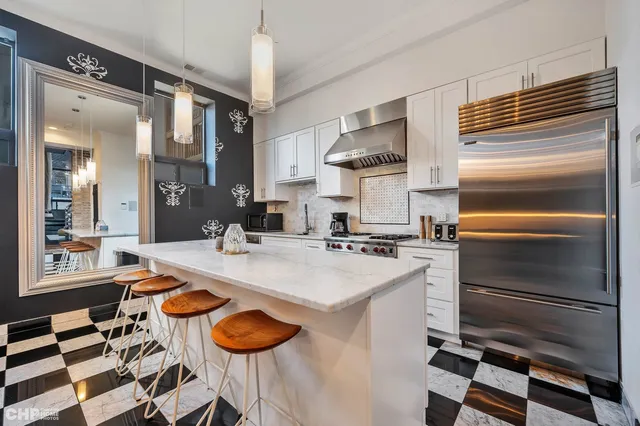 a kitchen with a sink appliances and cabinets