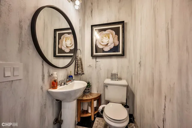 a bathroom with a toilet a sink and a mirror