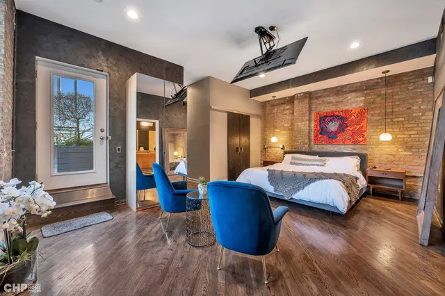 a bedroom with a bed and glass walk in closet