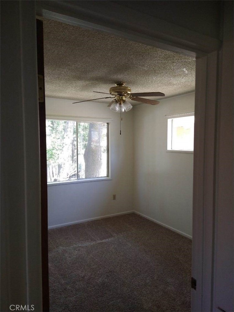 21988 Mojave River Road Cedarpines Park, CA 92322 - Photo 4 of 10 a view of an empty room and a window