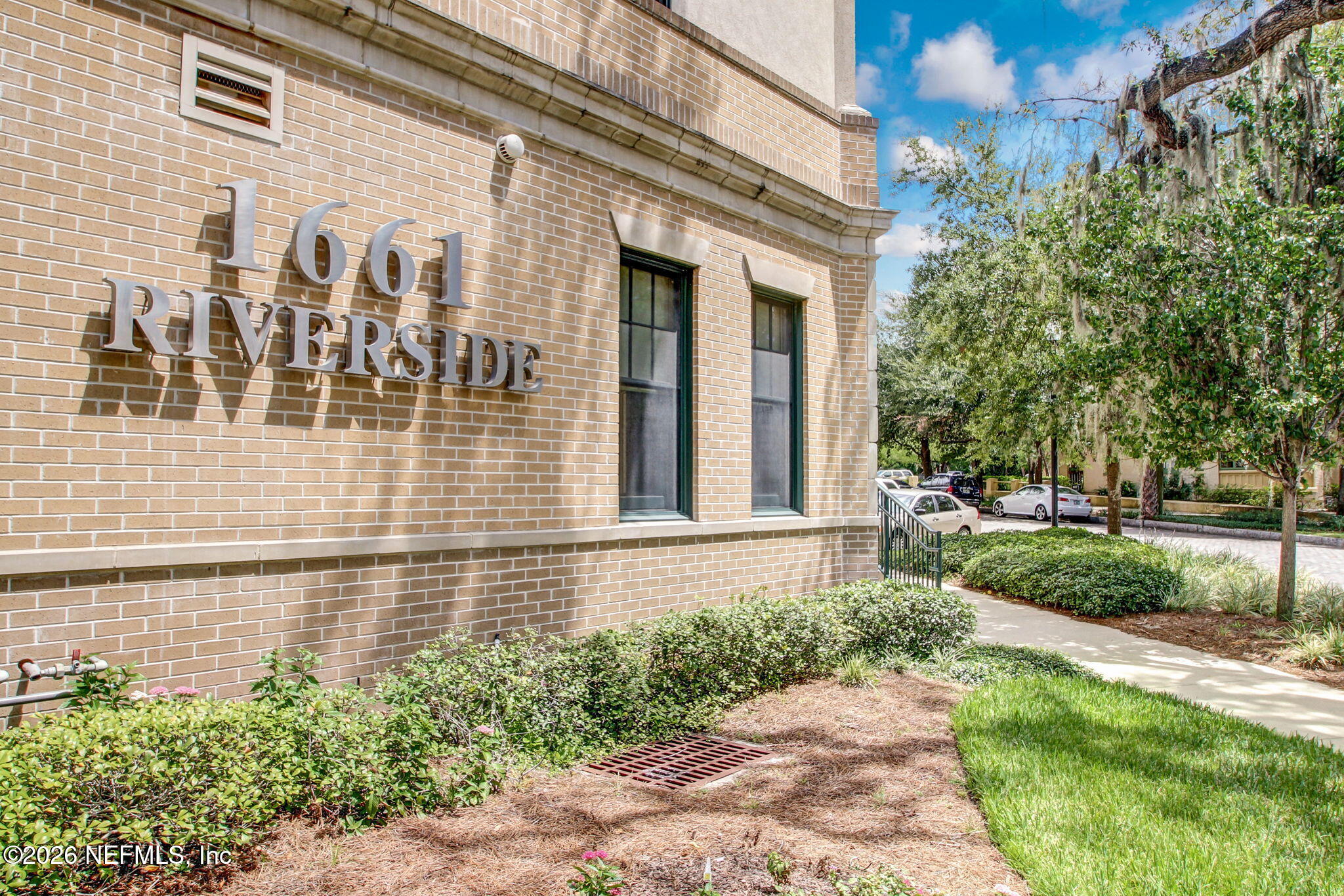 a view of a brick house with a yard