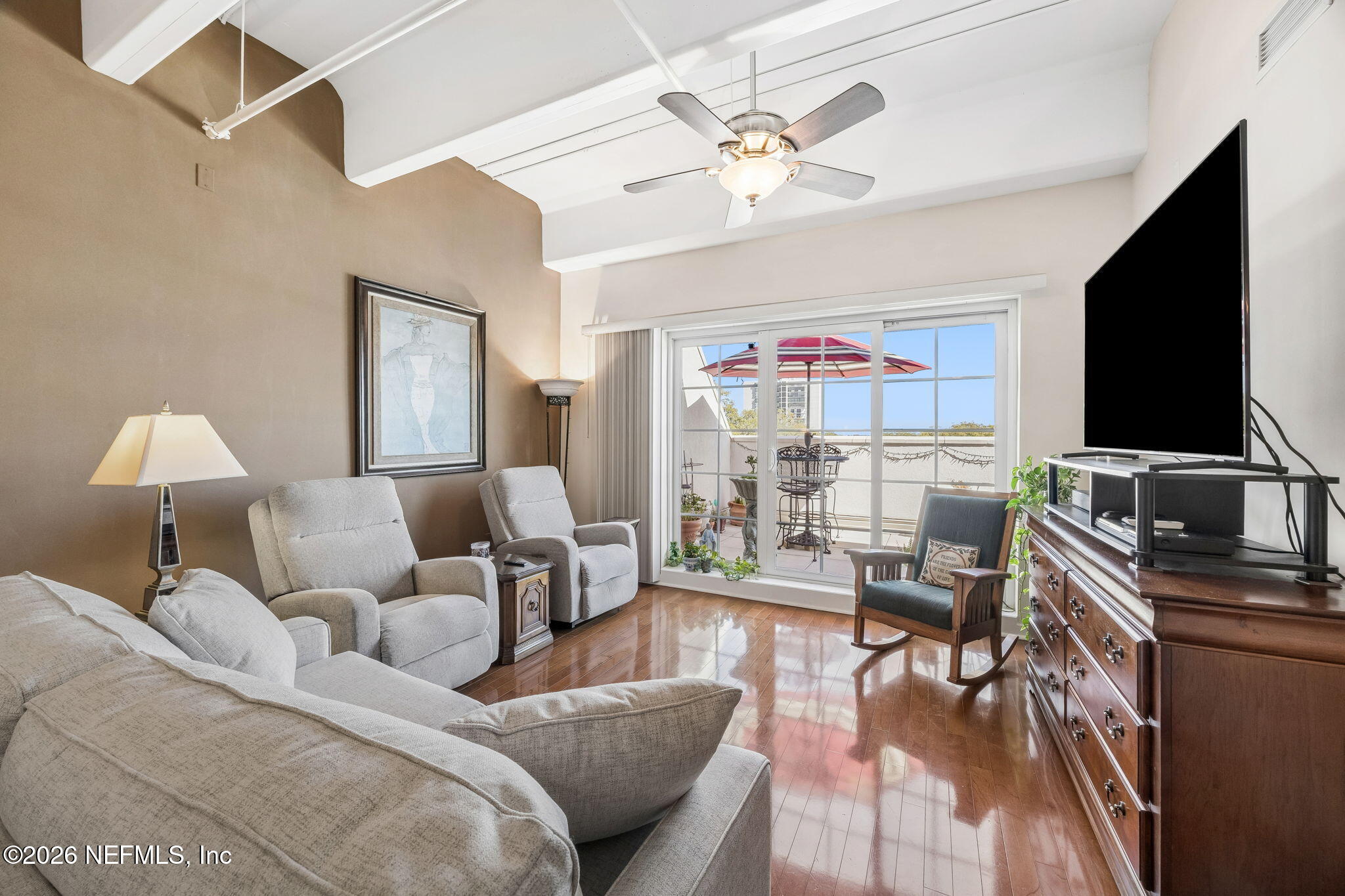 1661 Riverside Avenue, Unit 410 Jacksonville, FL 32204 - Photo 13 of 54 a living room with furniture a chandelier and a flat screen tv