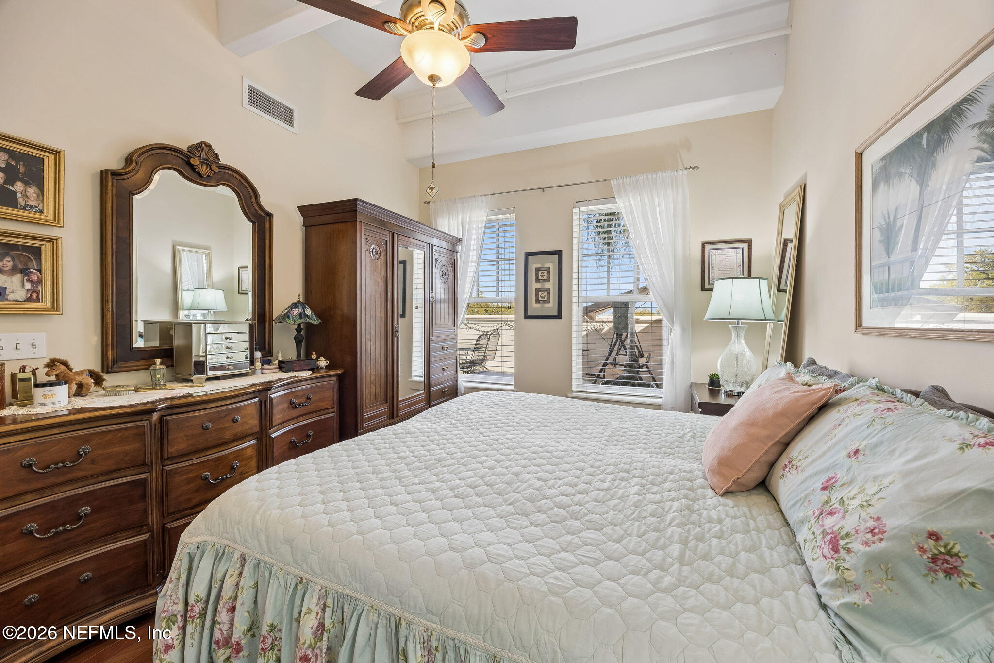 1661 Riverside Avenue, Unit 410 Jacksonville, FL 32204 - Photo 16 of 54 a bedroom with a large bed and a chandelier