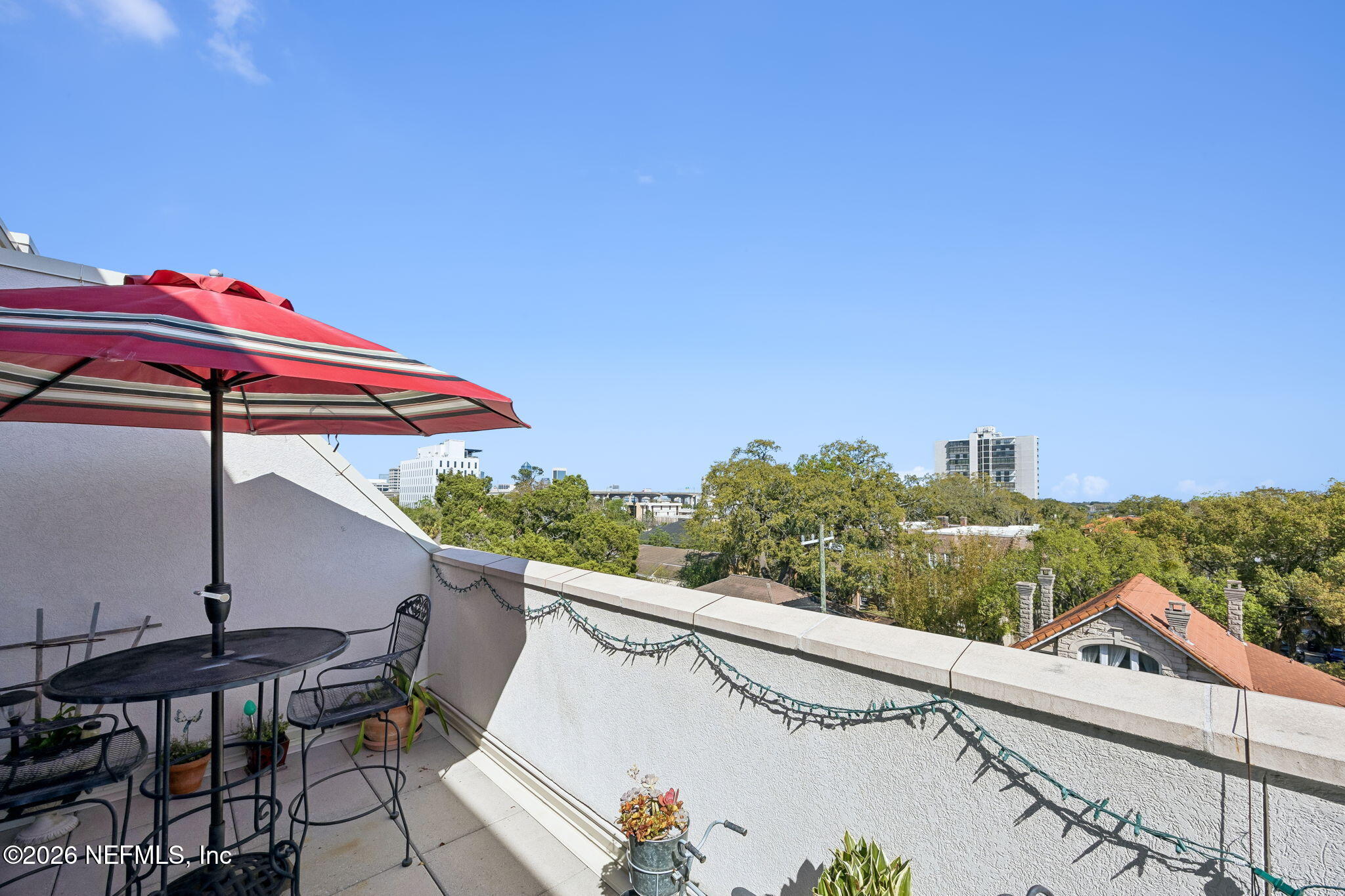 1661 Riverside Avenue, Unit 410 Jacksonville, FL 32204 - Photo 26 of 54 a view of a patio with a table and chairs under an umbrella