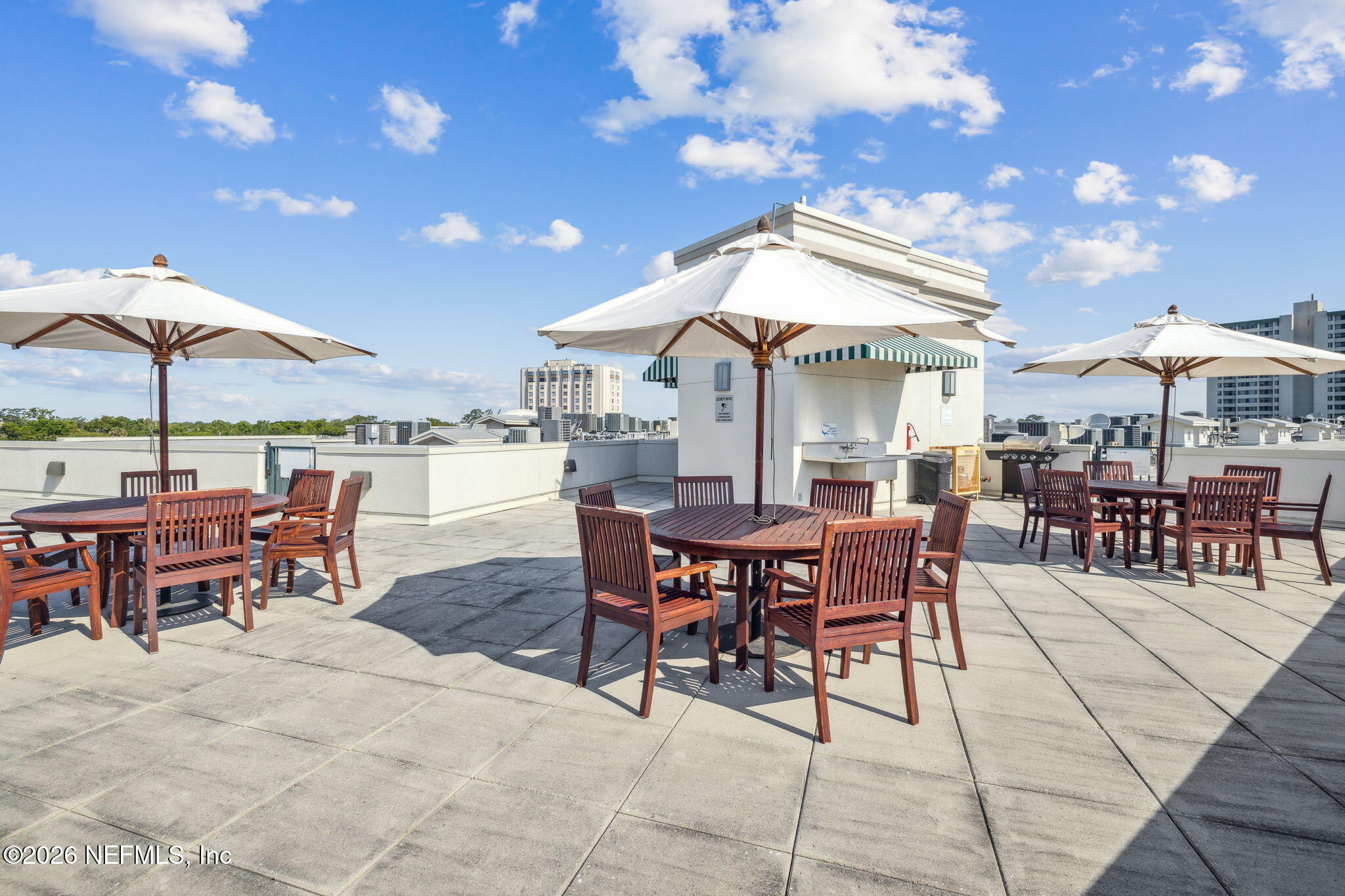 1661 Riverside Avenue, Unit 410 Jacksonville, FL 32204 - Photo 50 of 54 a view of a dinning table and chairs in the patio with a barbeque grill