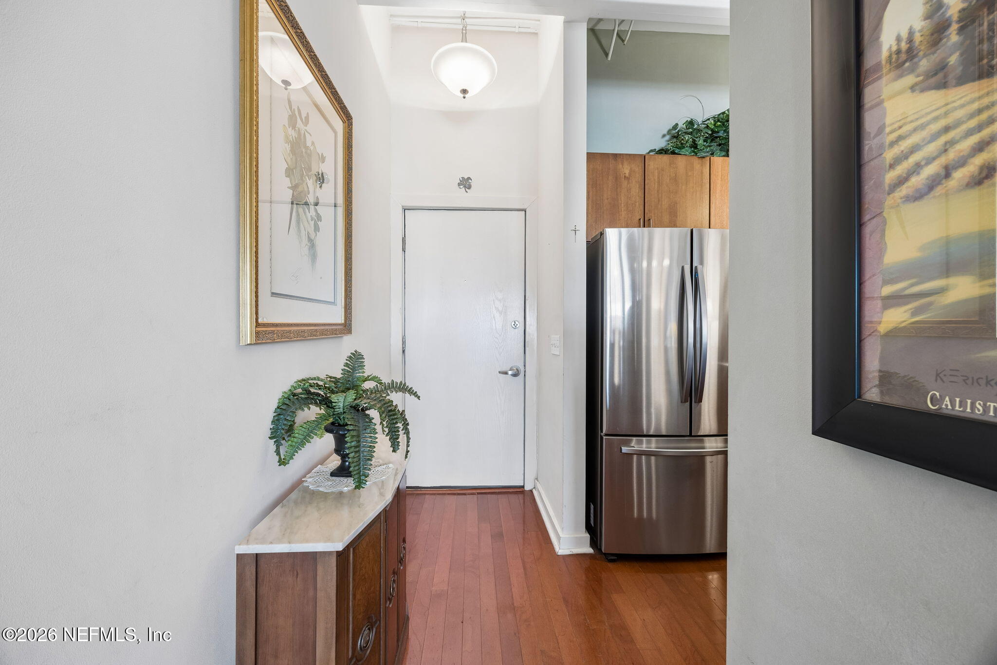 1661 Riverside Avenue, Unit 410 Jacksonville, FL 32204 - Photo 6 of 54 an empty room with wooden floor and a potted plant