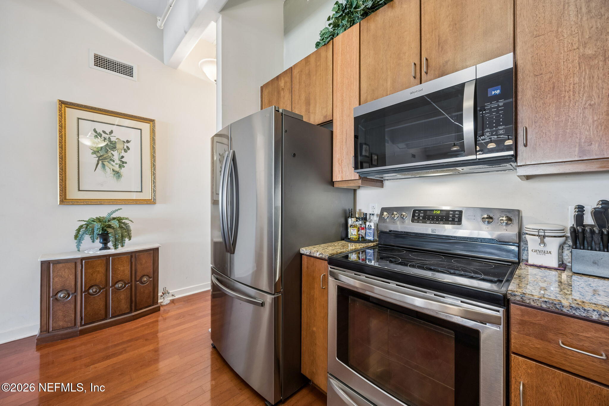1661 Riverside Avenue, Unit 410 Jacksonville, FL 32204 - Photo 10 of 54 a kitchen with stainless steel appliances a stove microwave and sink
