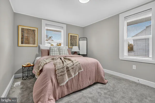 a bedroom with a bed and glass window
