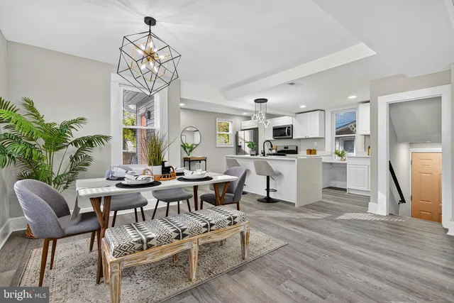 a living room with fireplace furniture and a chandelier