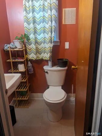 a white toilet sitting next to a shower curtain