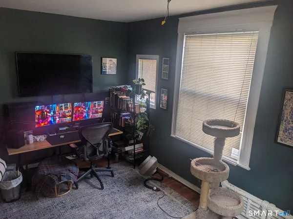 a room with furniture a air conditioner and a window