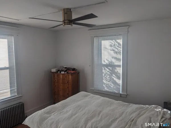 a bedroom with a bed and a window