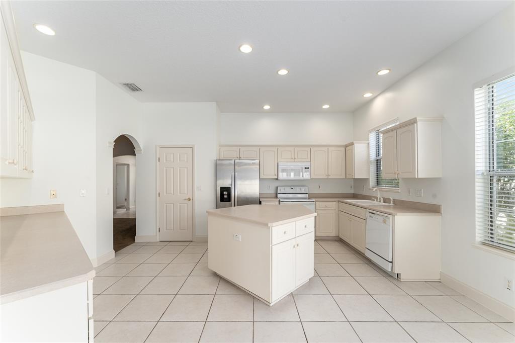 3003 Southwest 41st Place Ocala, FL 34474 - Photo 11 of 51 a kitchen with white cabinets appliances and a window