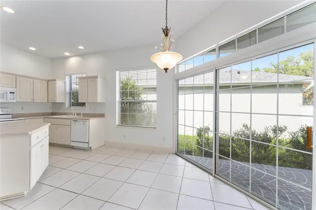 a large kitchen with a large window and cabinets