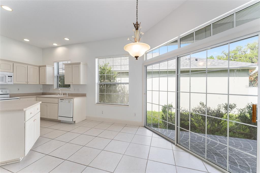3003 Southwest 41st Place Ocala, FL 34474 - Photo 13 of 51 a large kitchen with a large window and cabinets