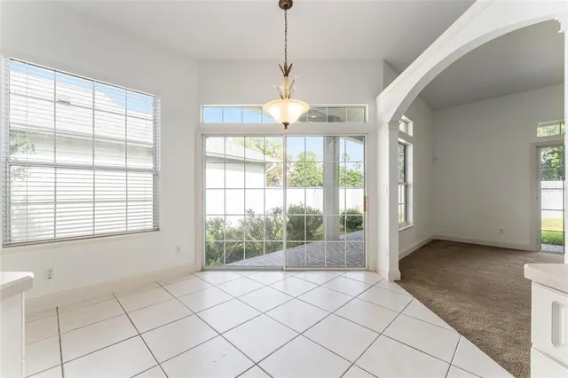 a view of a dining room with furniture and chandelier
