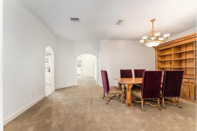 a dining room with furniture and chandelier