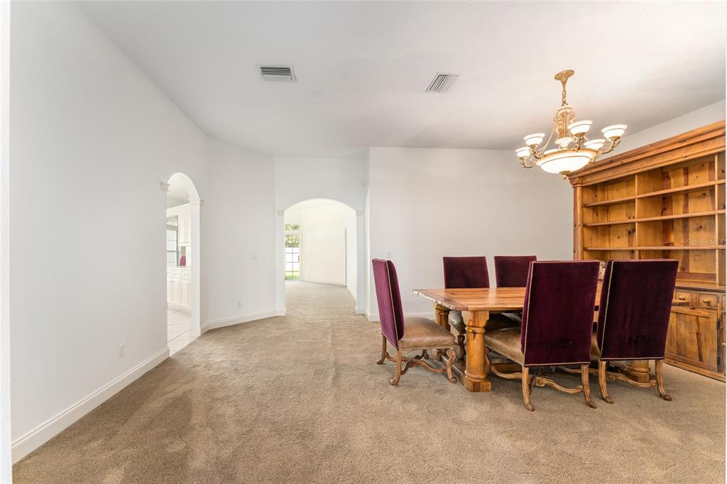 3003 Southwest 41st Place Ocala, FL 34474 - Photo 17 of 51 a view of a dining room with furniture and chandelier