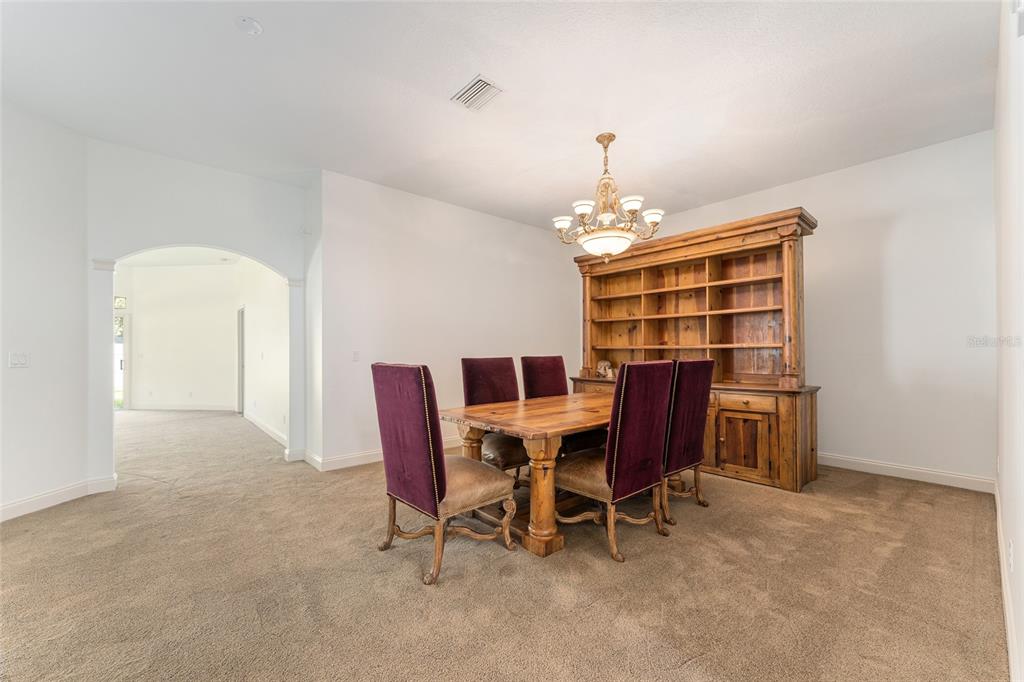 3003 Southwest 41st Place Ocala, FL 34474 - Photo 18 of 51 a dining room with furniture and chandelier