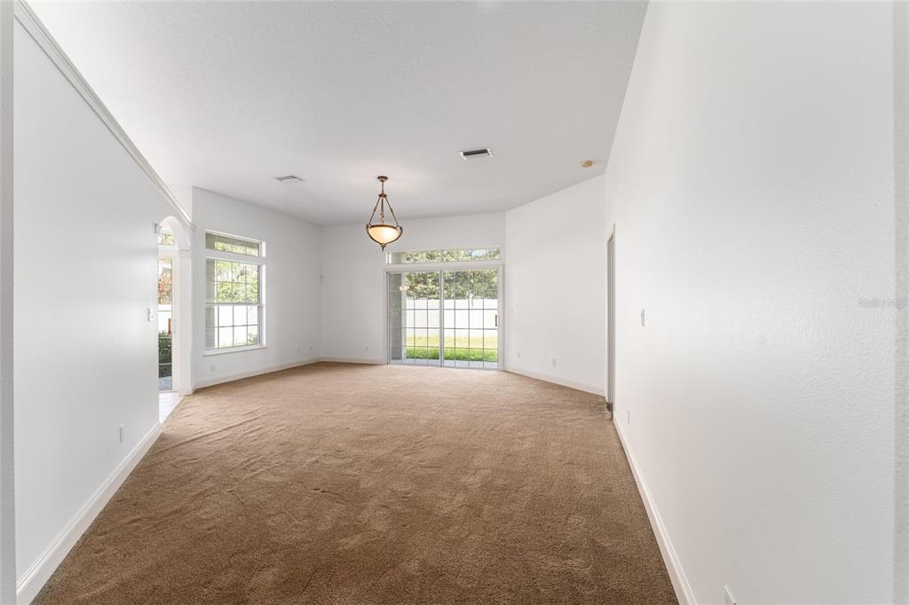 3003 Southwest 41st Place Ocala, FL 34474 - Photo 22 of 51 a view of a big room with windows and chandelier fan