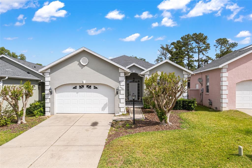 3003 Southwest 41st Place Ocala, FL 34474 - Photo 3 of 51 a front view of a house with garden