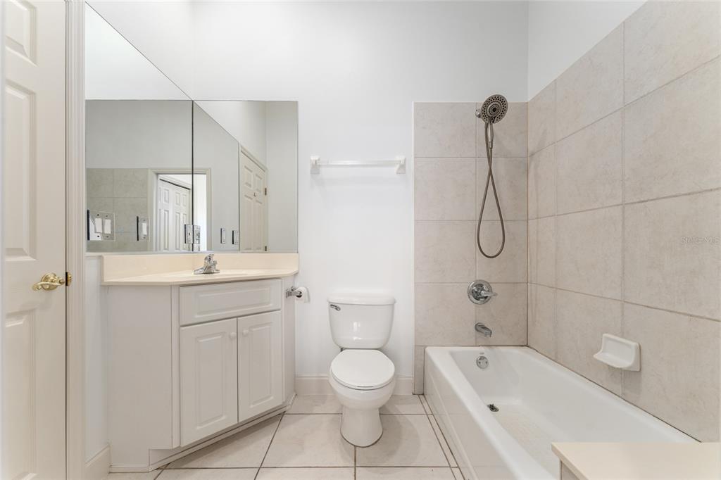 3003 Southwest 41st Place Ocala, FL 34474 - Photo 31 of 51 a bathroom with a granite countertop sink a toilet and shower