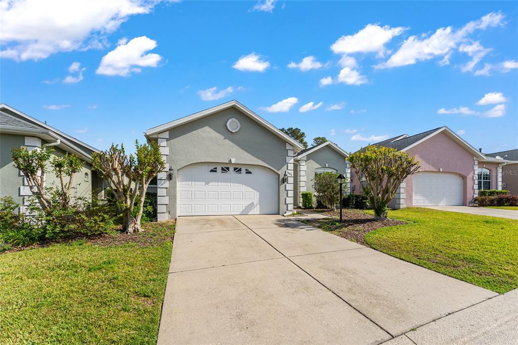 3003 Southwest 41st Place Ocala, FL 34474 - Photo 4 of 51 a front view of a house with a yard and garage